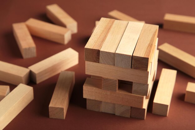 Blocks of wood on brown background Strategy game as a business plan for team work