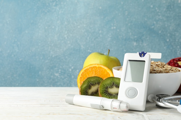 Bloedglucosemeter en diabetisch voedsel op houten tafel