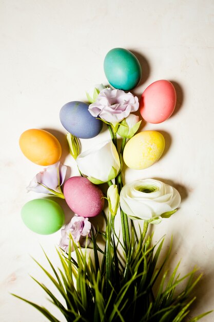 Bloemen en eieren op roze mable achtergrond, kopieer ruimte voor paasgroeten