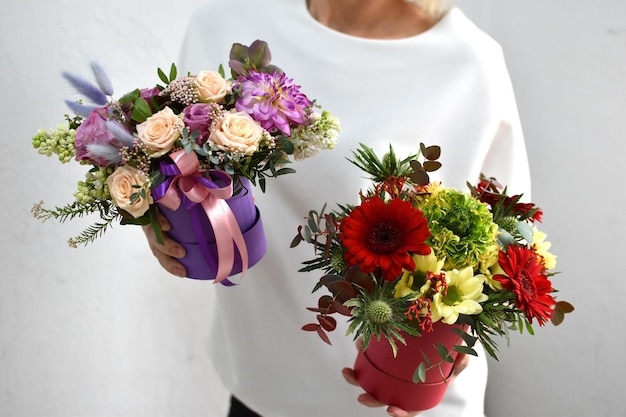 Bloemen in hoedendoos vrouw met een boeket bloemen online catalogus van bloemenbezorgwinkel plantensamenstelling