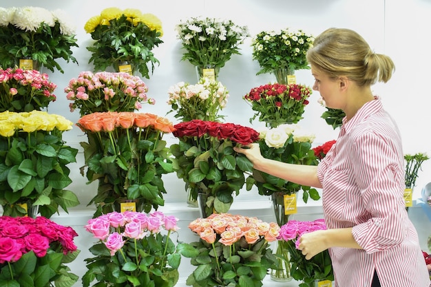 Bloemenwinkel, vrouw kiest rozen in de winkel.