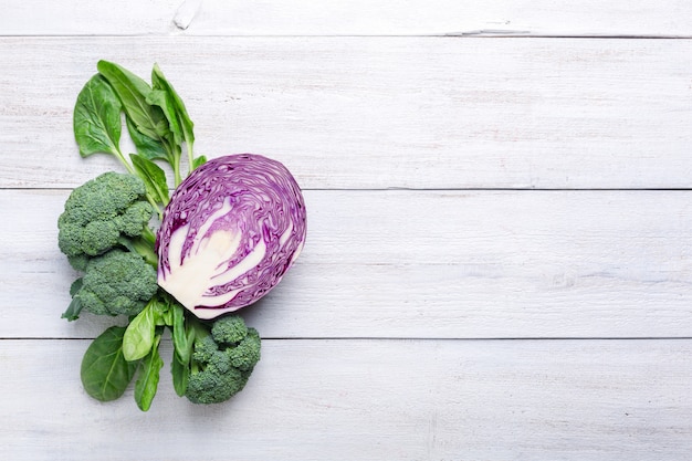 Foto bloemkool, broccoli en blauwe kool op een witte houten achtergrond. achtergrondmenu eten.