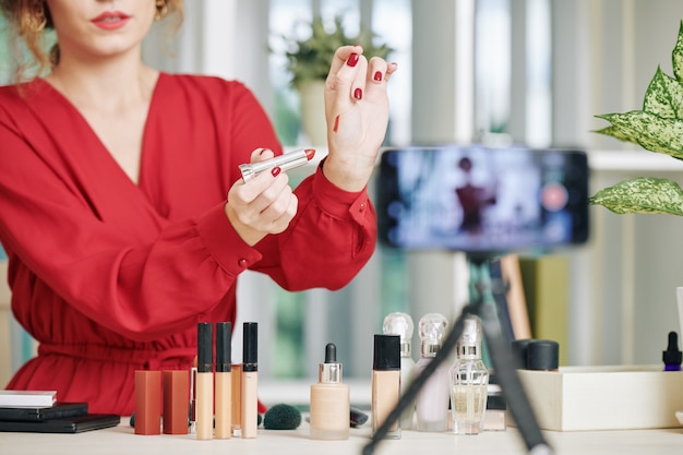 Blogger making lipstick swatch