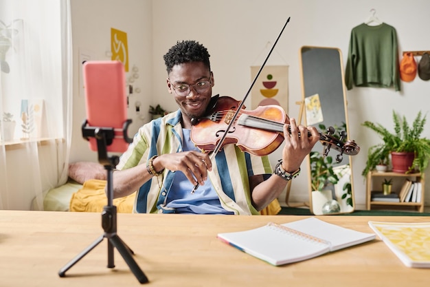 Blogger playing violin during online broadcast