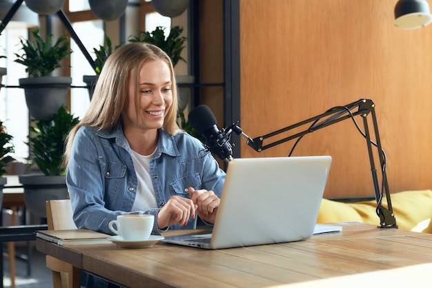 Blogger woman talking with followers online by laptop