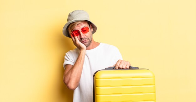 blond adult man feeling bored, frustrated and sleepy after a tiresome. traveler concept