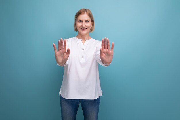 Blond bob middleaged woman in a white blouse in menopause on a studio background