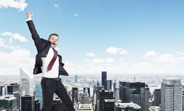 Blond businessman jumping cityscape