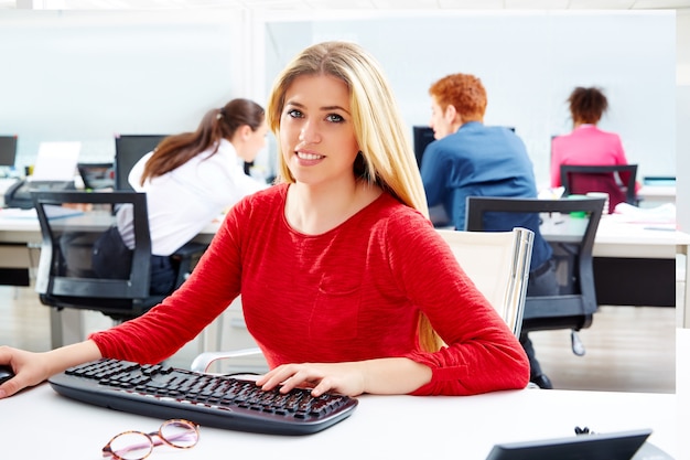 Blond businesswoman working office with computer