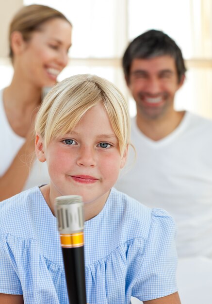 Blond child singing with a microphone