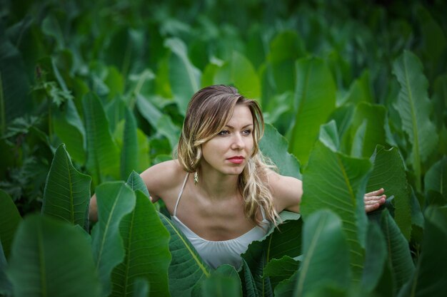 Blond girl in grapes leaves