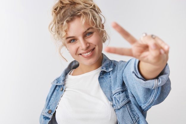 blond girl show victory gesture