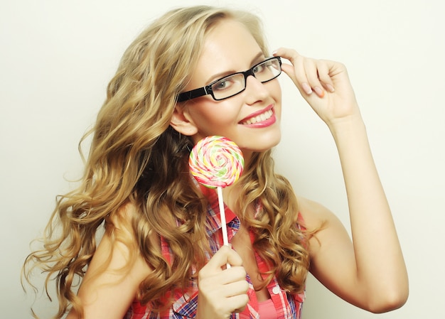 Photo blond  girl with  lolipop