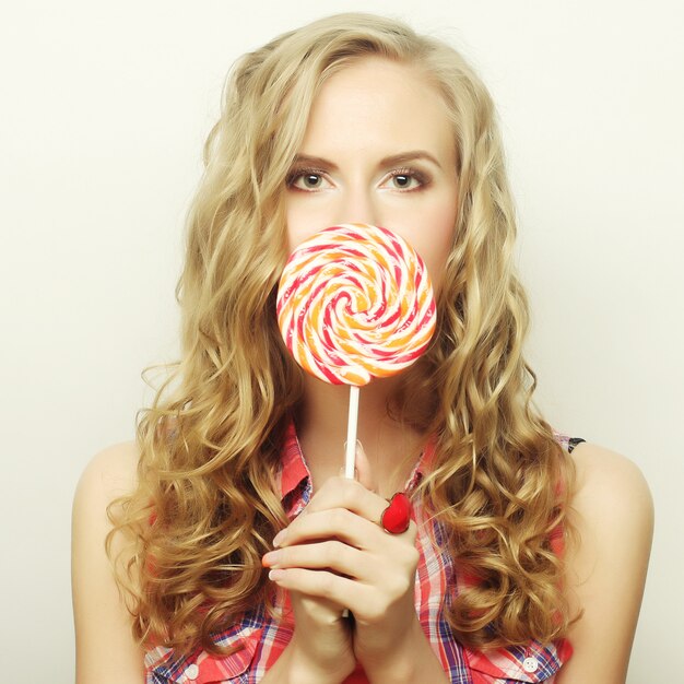 Photo blond  girl with lollipop