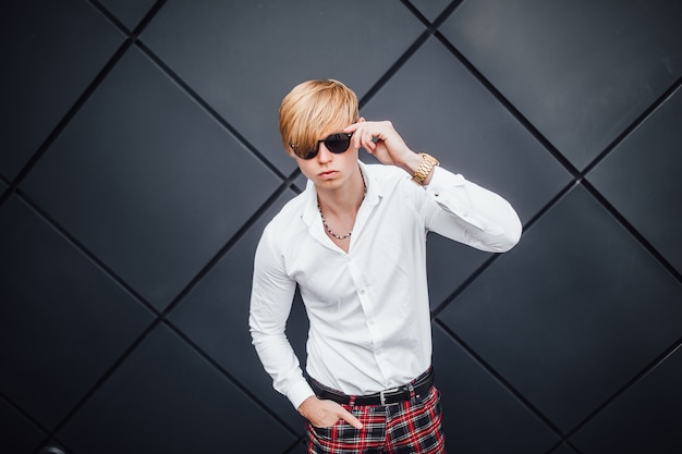 Blond guy wearing sunglasses and a white shirt