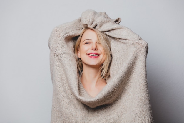 Blond hair girl in sweater on white background