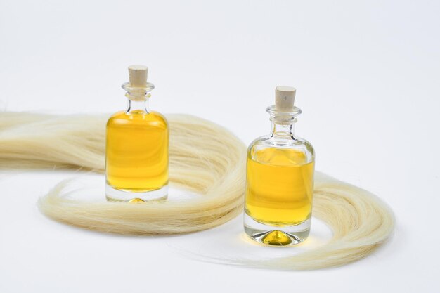 Blond hair and oil bottles isolated on white background