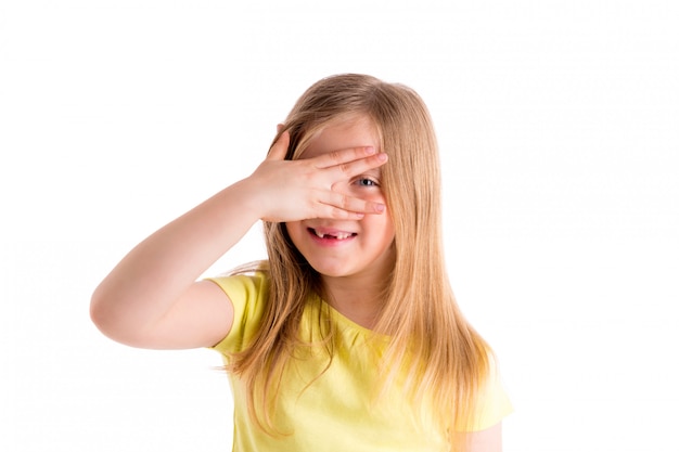 Blond indented kid girl hiding eyes with fingers