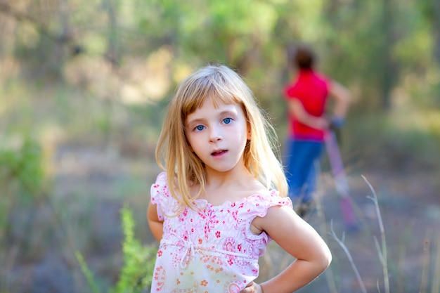 blond kid girl in forest park 