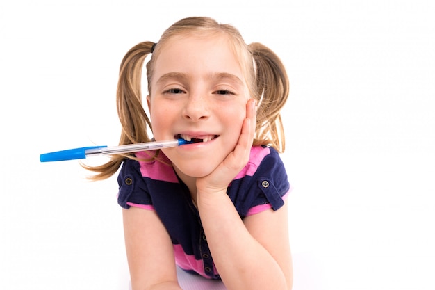 Photo blond kid girl student with spiral notebook in desk