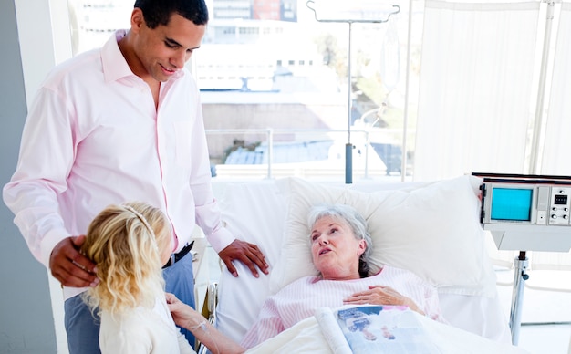 Blond little girl with her father visiting her grandmother