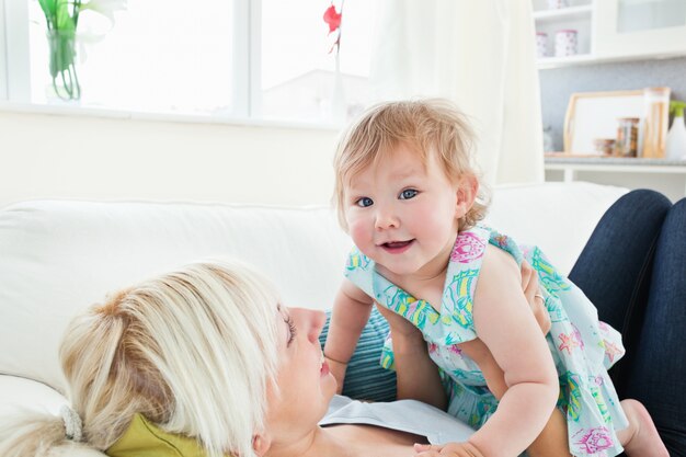 blond mother playing with her daughter