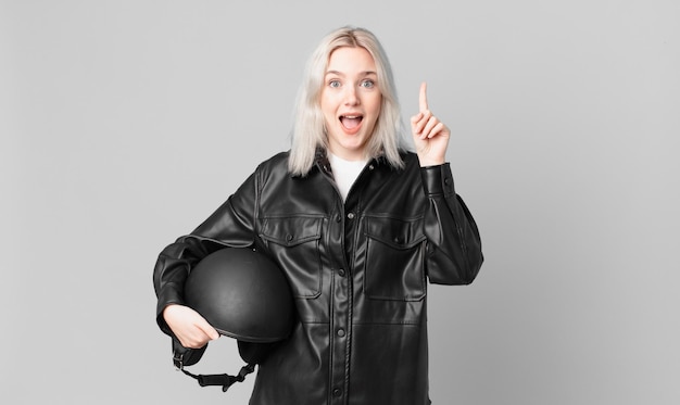 Blond pretty woman feeling like a happy and excited genius after realizing an idea. motorbike rider concept