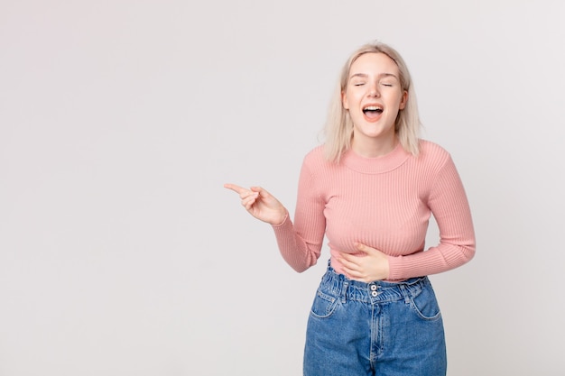 Blond pretty woman laughing out loud at some hilarious joke