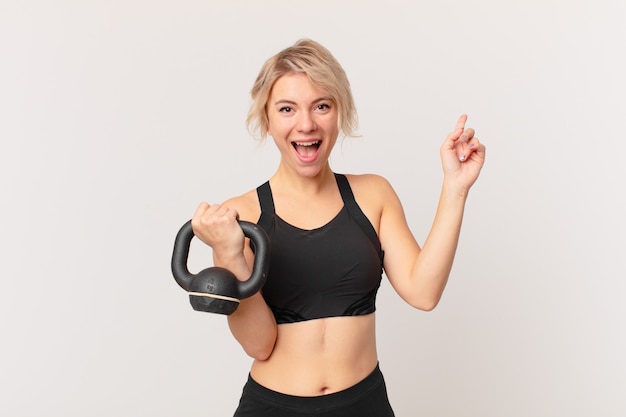 Blond pretty woman lifting a dumbbell