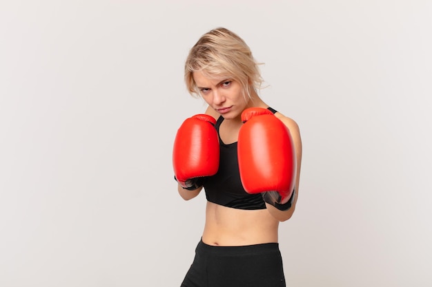 Blond pretty woman with boxing gloves