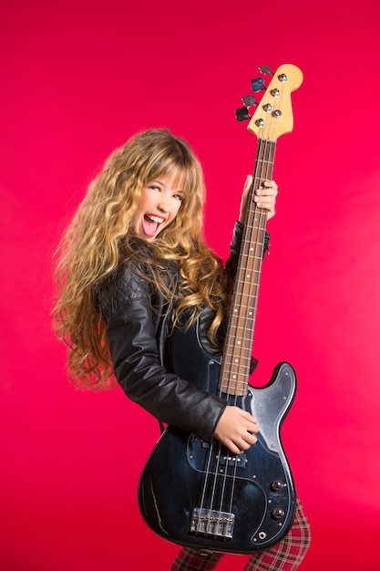 Blond Rock and roll girl with bass guitar on red