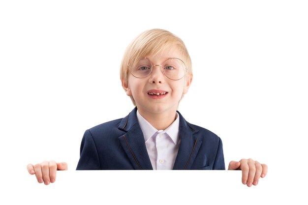 Blond smiling schoolboy in big glasses holds a large white poster Boy with a billboard Place for your text Copy space