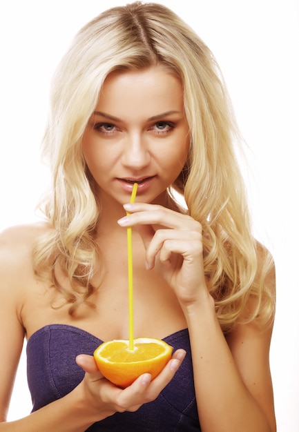 Blond woman drinking juice with straw