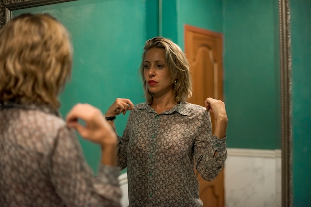 Blond woman getting ready in a restroom