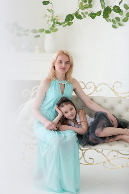 Blond woman in greek dress with daughter