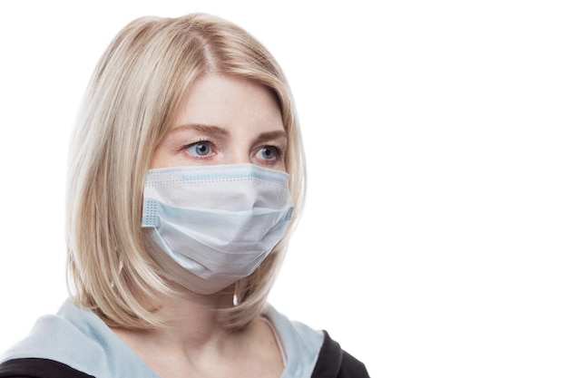 Blond woman in medical mask.