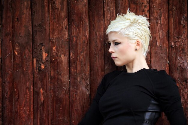 Blond Woman near the Wood Wall in Park