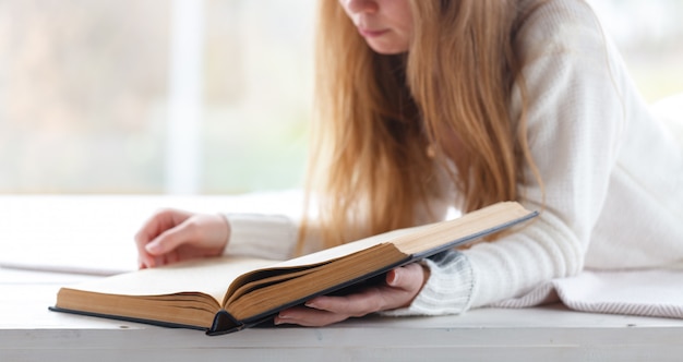 Blond woman reading book