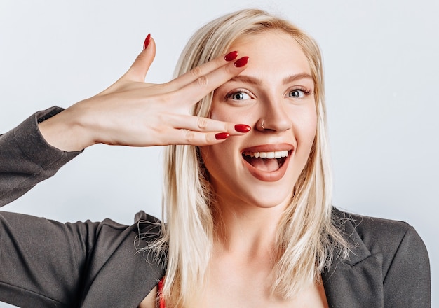 Photo blond woman showing peace on white isolated space