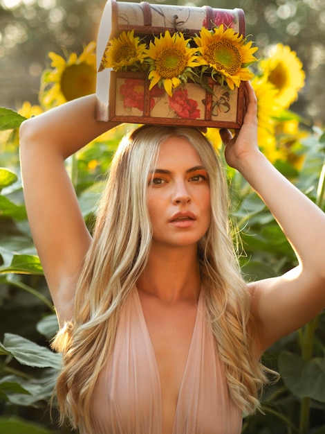Blond woman with blooming flowers in box