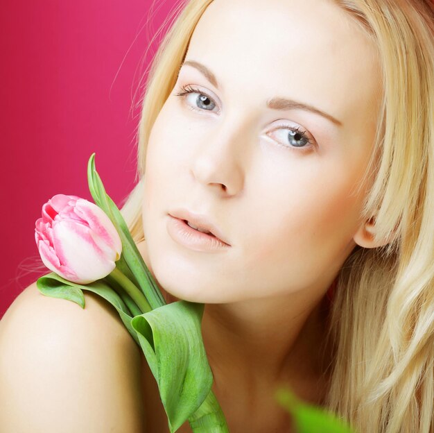 Blond woman with pink tulip