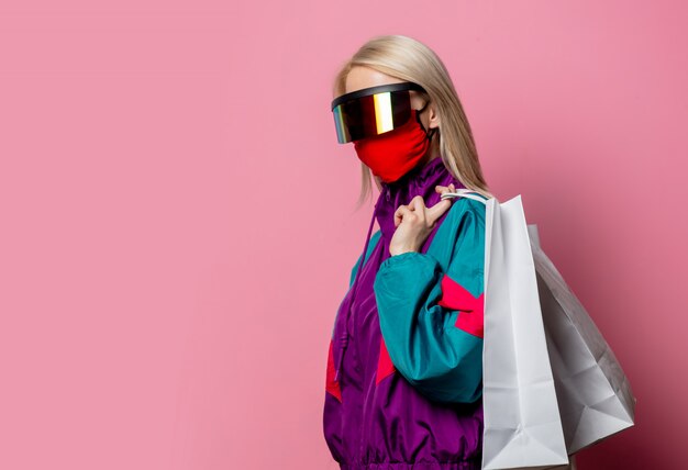 Blonde in 80s clothes and face mask with shopping bags