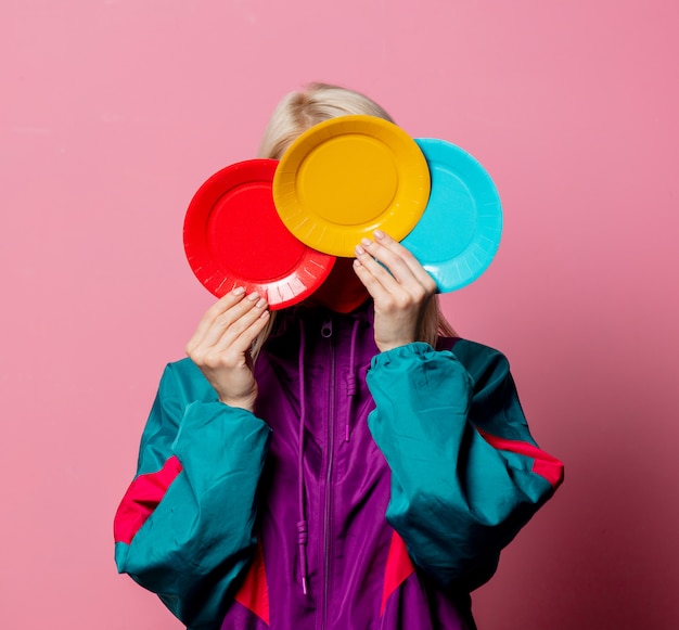 Blonde in 80s clothes with colored plates