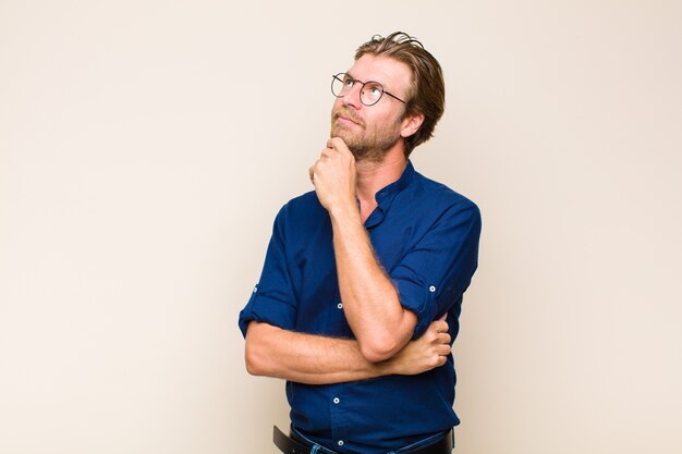 Blonde adult blonde man wearing glasses isolated