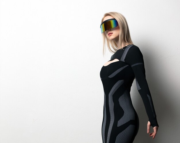 Blonde android female in VR glasses and suit on white background.