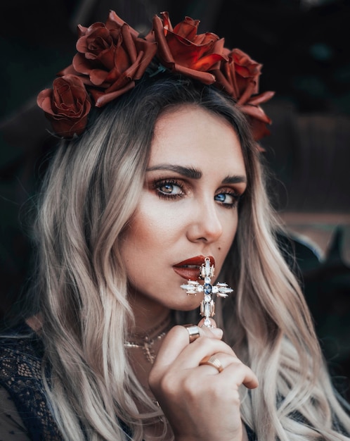 Blonde beautiful girl posing with a cross