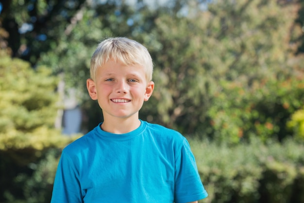 Blonde boy smiling at camera