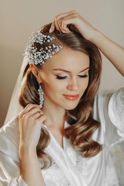 blonde bride with beautiful hair and makeup getting ready for the wedding ceremony Vertical photo