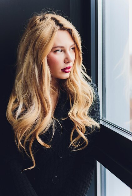 Blonde business woman in a black suit