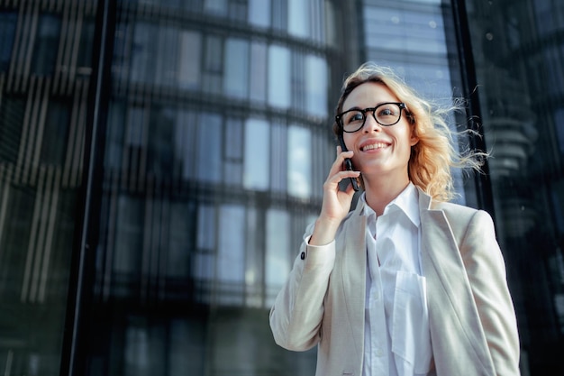 A blonde business woman Talking to a client about a new project on the phone A manager going to work